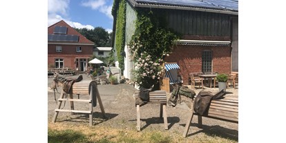 Urlaub auf dem Bauernhof - Schleswig-Holstein - Holzpferde und Sitzplätze - Warfthof Wollatz - Nordseeurlaub mit Feinsinn
